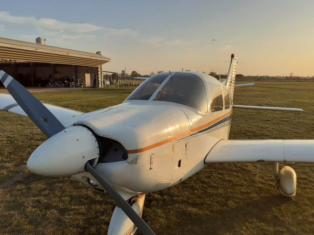 Fly With Me aircraft by the hangar at sunset